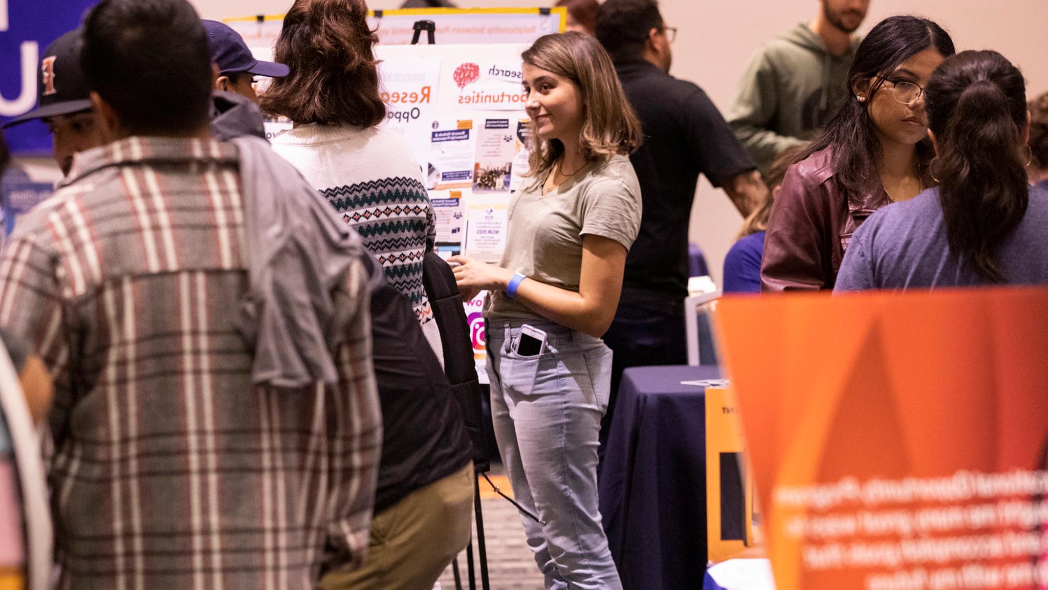Student standing at resource fair